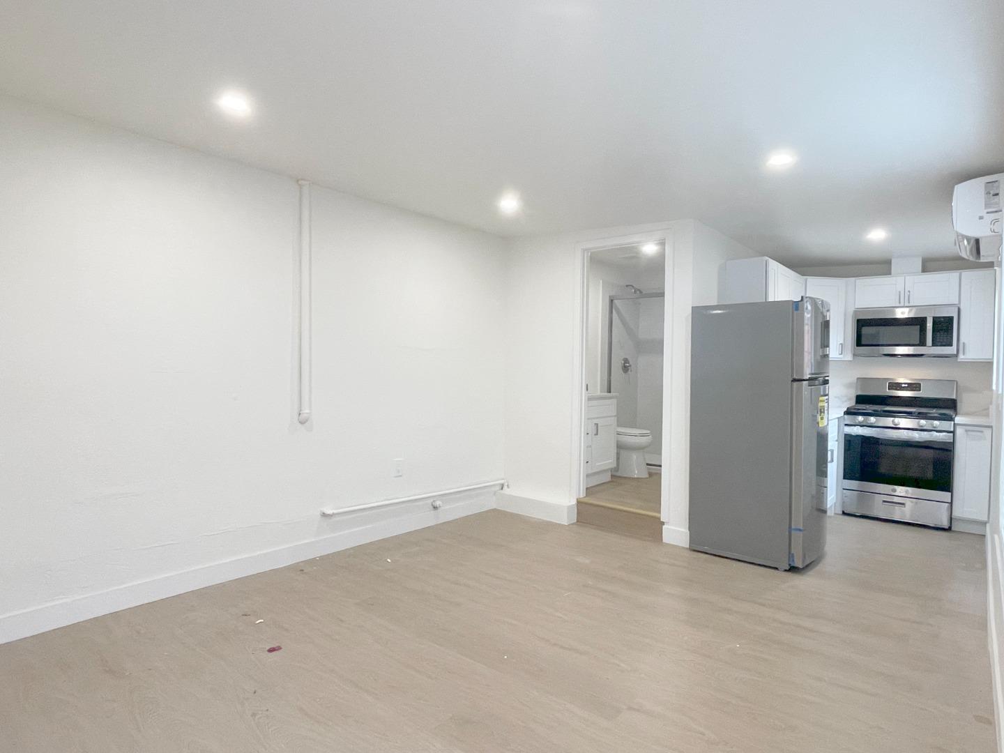 1758 5th Street, Unit STUDIO Livermore, CA 94550 - Photo 4 of 6 an empty room with kitchen and stainless steel appliances