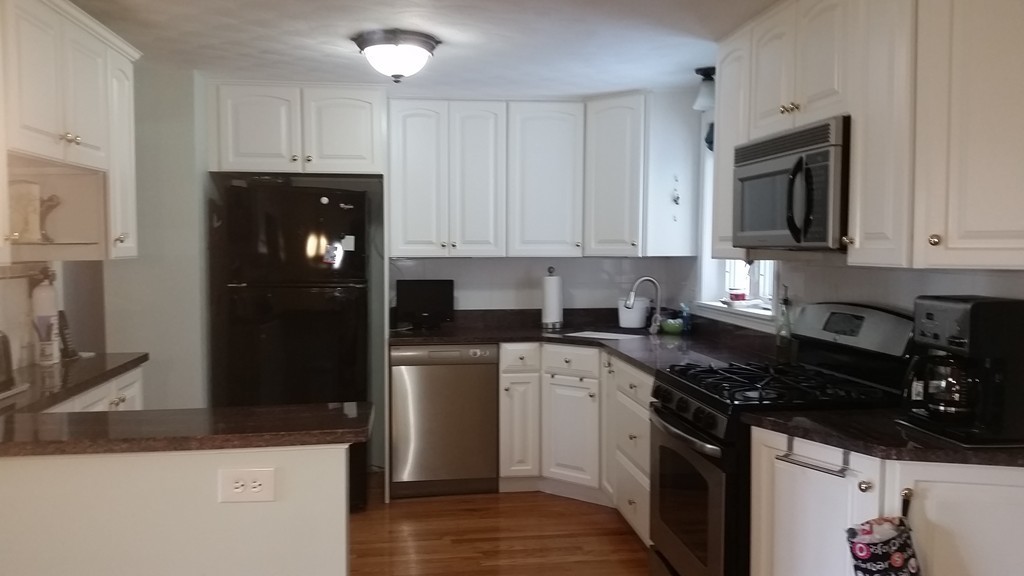 107 Allen Road Billerica, MA 01821 - Photo 3 of 24 a kitchen with a sink and a stove top oven