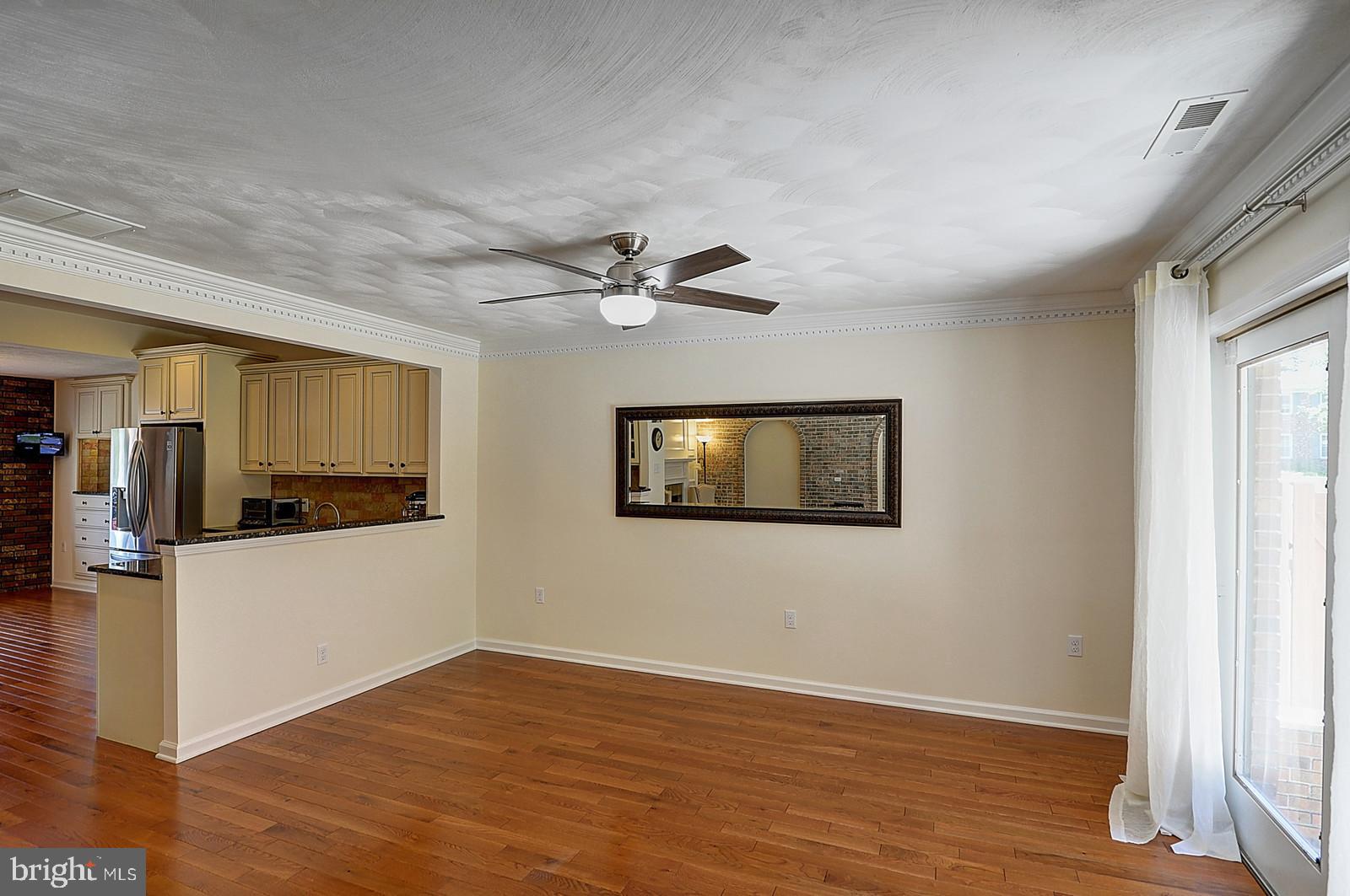 1 Cavalier Drive Hamilton, NJ 08619 - Photo 11 of 44 a view of an empty room with wooden floor and a window