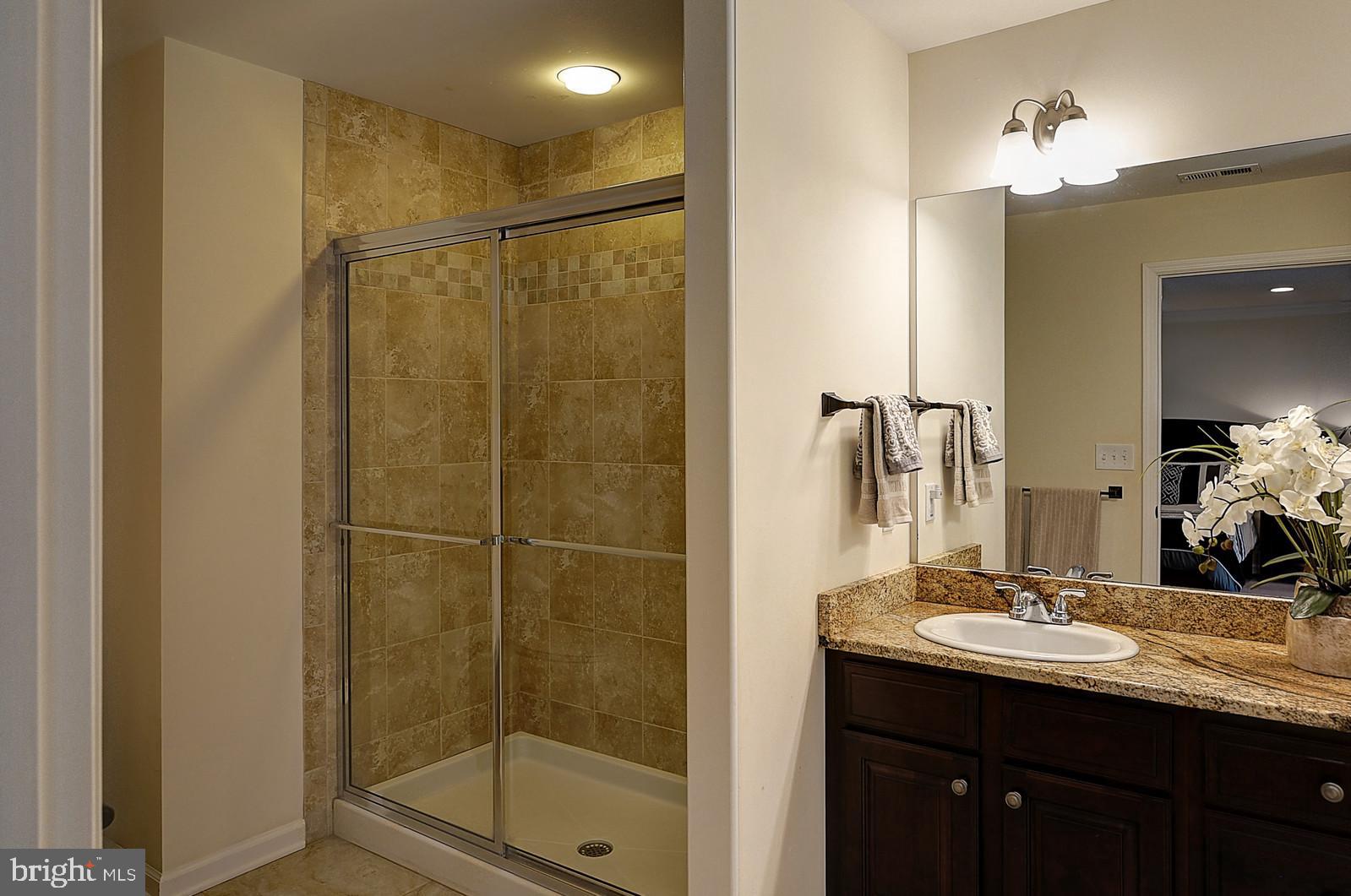 1 Cavalier Drive Hamilton, NJ 08619 - Photo 18 of 44 a bathroom with a shower sink and mirror