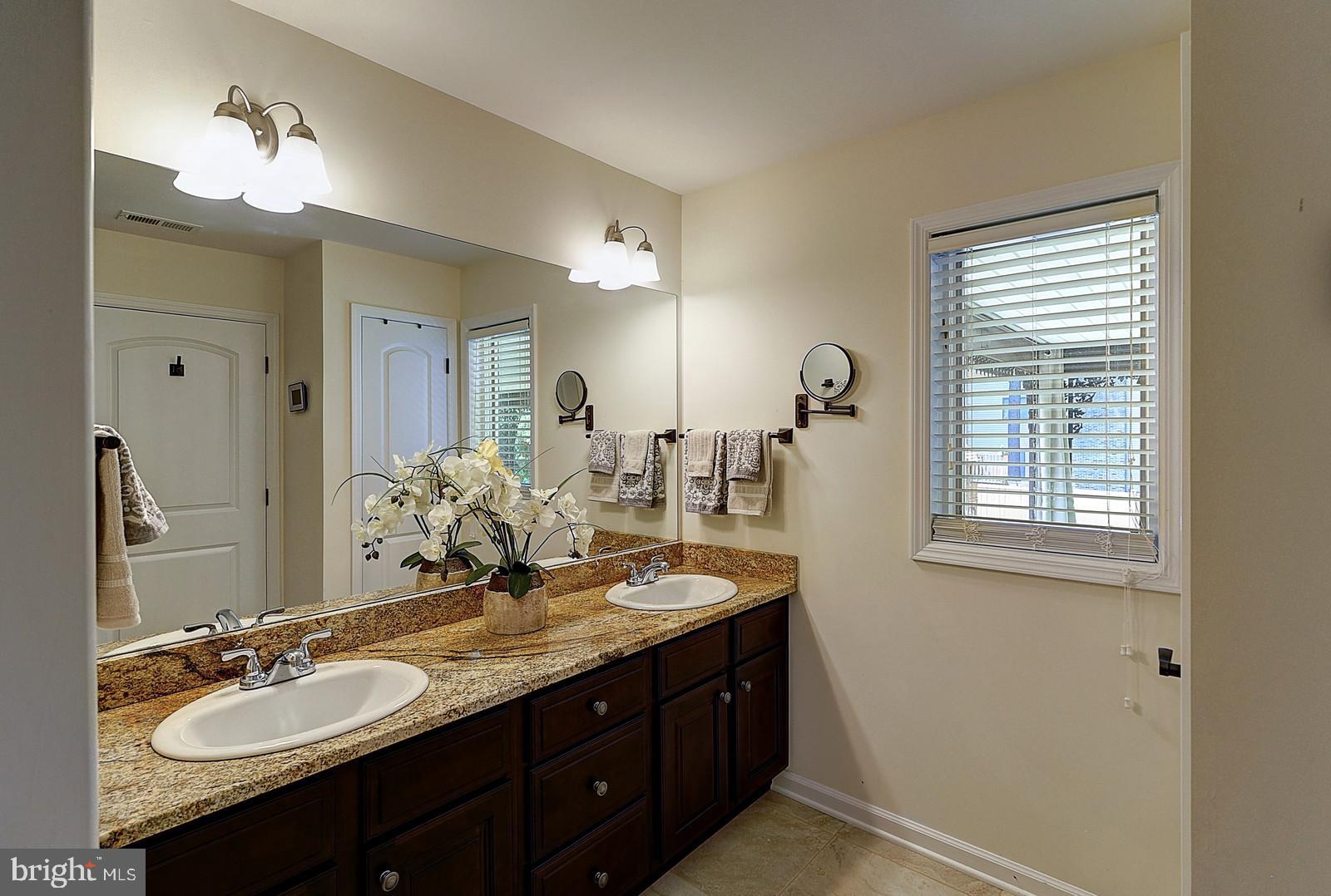 1 Cavalier Drive Hamilton, NJ 08619 - Photo 19 of 44 a bathroom with a granite countertop sink double and mirror