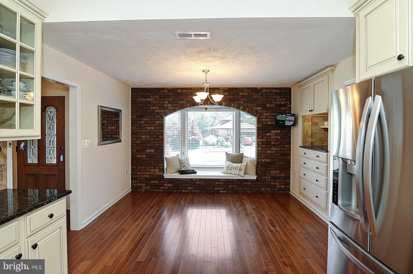 1 Cavalier Drive Hamilton, NJ 08619 - Photo 6 of 44 a view of a kitchen with a refrigerator a stove top oven and wooden floor