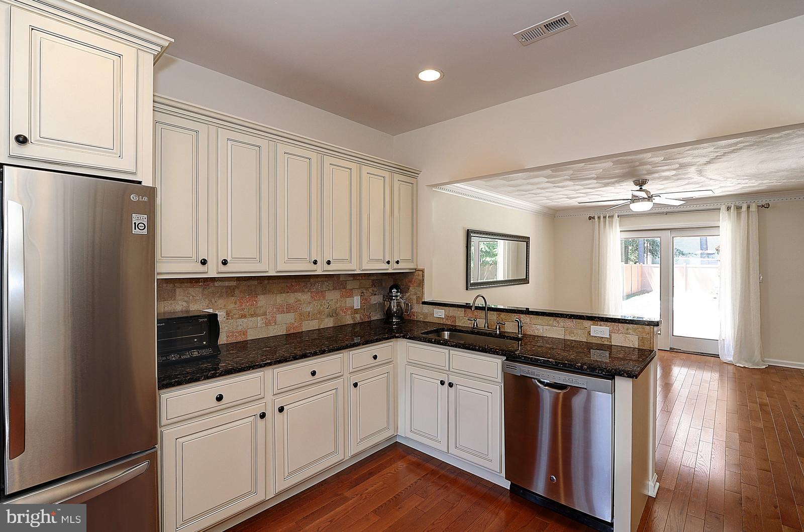 1 Cavalier Drive Hamilton, NJ 08619 - Photo 10 of 44 a kitchen with granite countertop a sink and cabinets