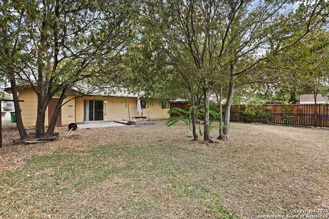 a view of a house with a backyard