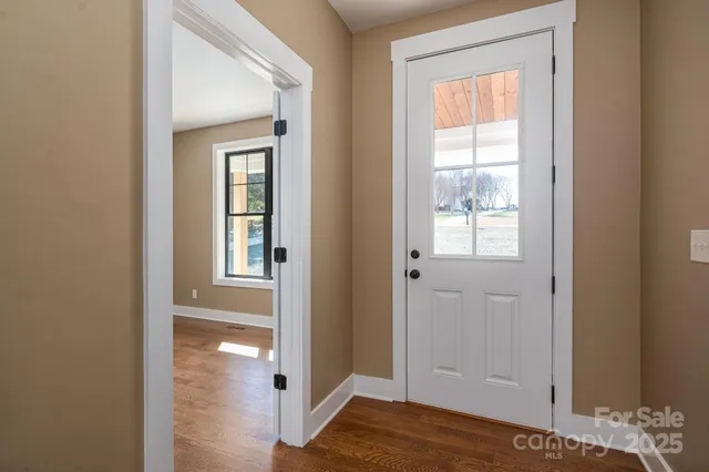 a kitchen with stainless steel appliances granite countertop a stove a sink and white cabinets