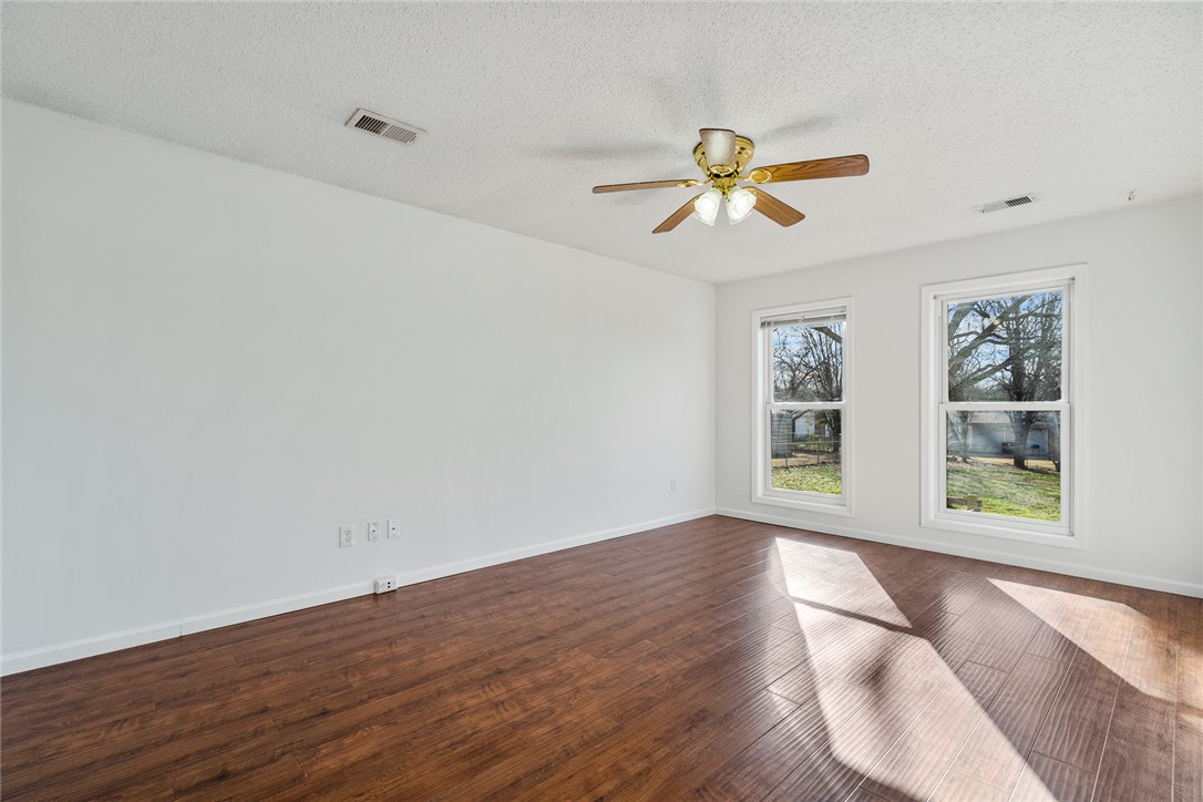 2305 Millgate Road Anderson, SC 29621 - Photo 10 of 18 Rich hardwood-style flooring and abundant natural light create an inviting atmosphere in this versatile space.