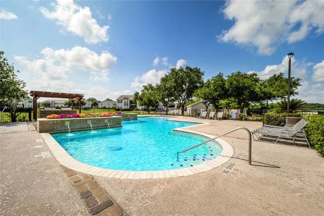 a view of a swimming pool with a yard