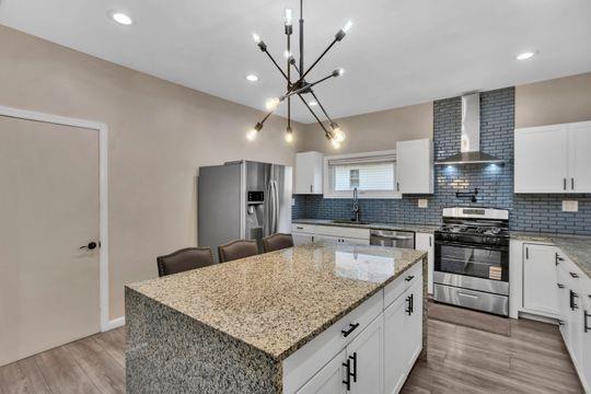 1850 Middle Street Pittsburgh, PA 15215 - Photo 16 of 27 a kitchen with stainless steel appliances granite countertop a sink stove and refrigerator