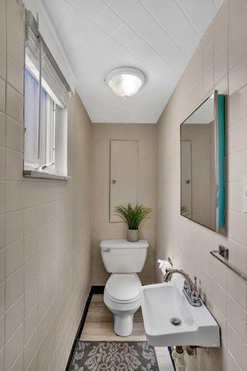 1850 Middle Street Pittsburgh, PA 15215 - Photo 24 of 27 a bathroom with a toilet a sink and mirror