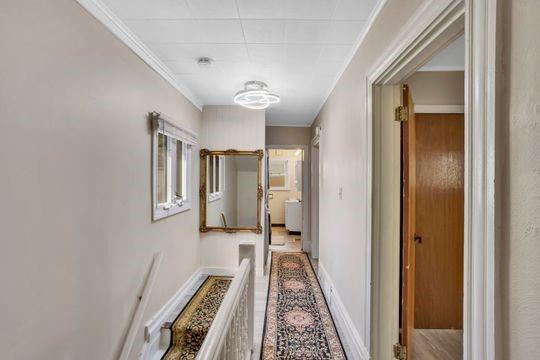 1850 Middle Street Pittsburgh, PA 15215 - Photo 25 of 27 a view of a hallway with wooden floor and staircase