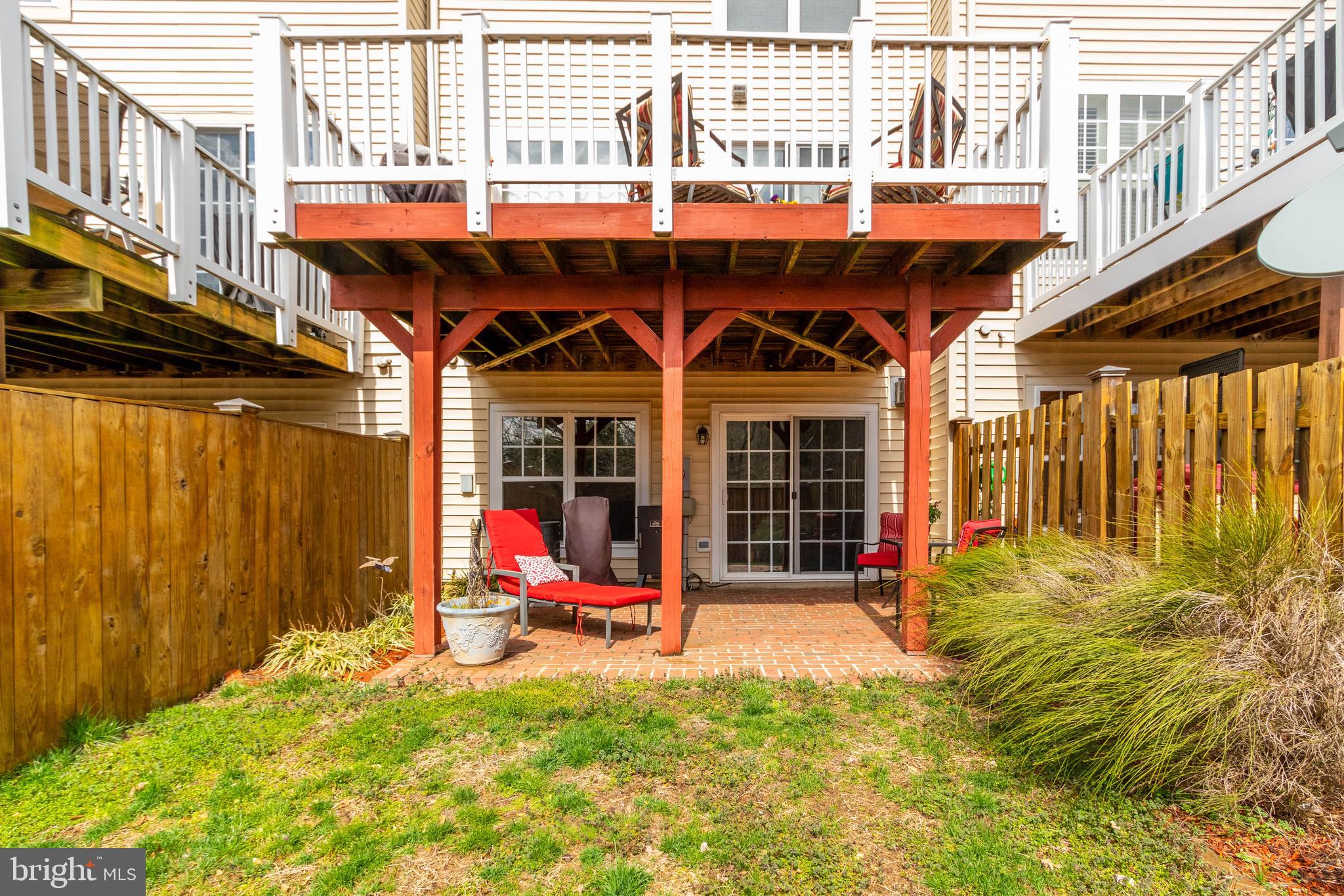 9185 Ribbon Falls Loop Bristow, VA 20136 - Photo 32 of 34 Fenced Backyard Retreat with Brick Patio