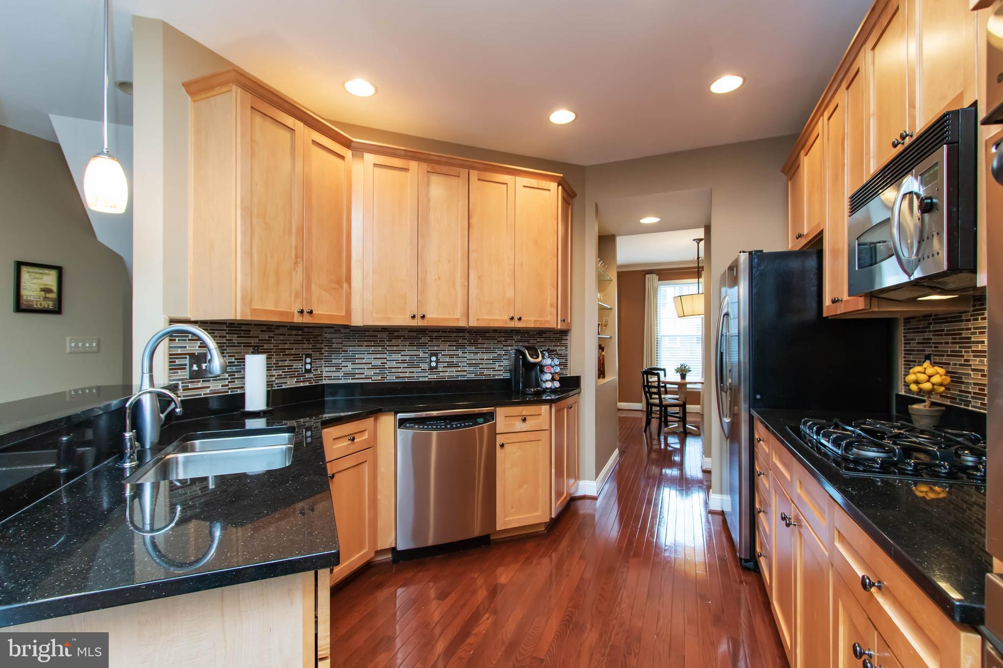 9185 Ribbon Falls Loop Bristow, VA 20136 - Photo 7 of 34 Gourmet Kitchen w/Granite and Upgraded Maple Cabs