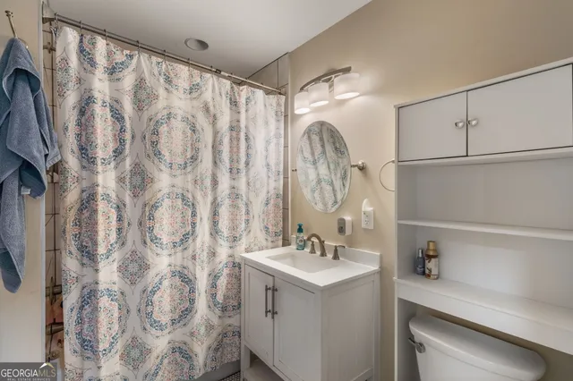 a bathroom with a sink vanity mirror and shower