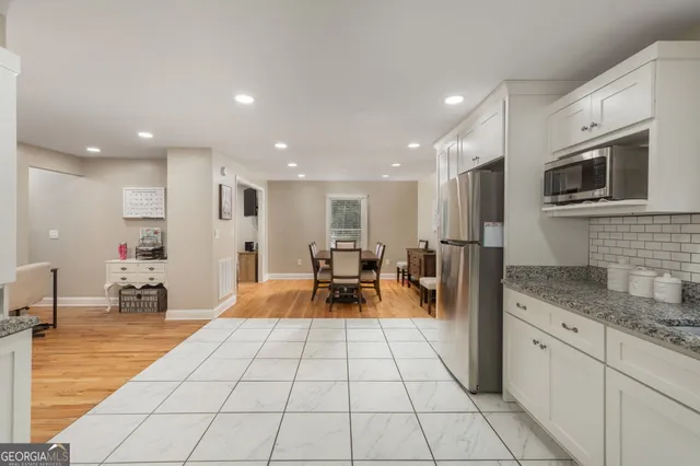 a kitchen with stainless steel appliances granite countertop a refrigerator and a sink