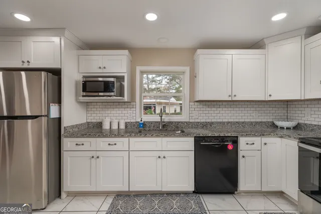 a kitchen with a sink stove and refrigerator