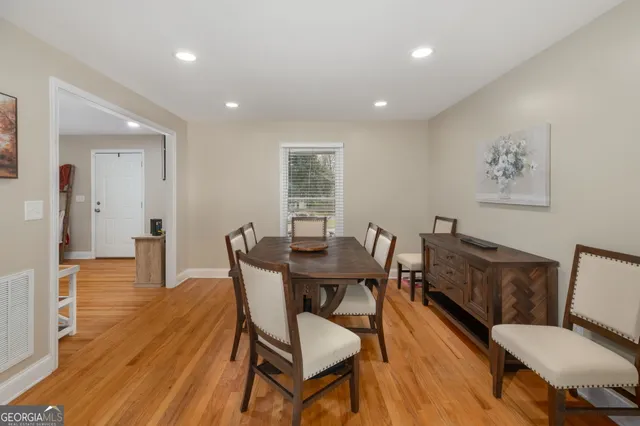a view of a dining room with furniture and wooden floor