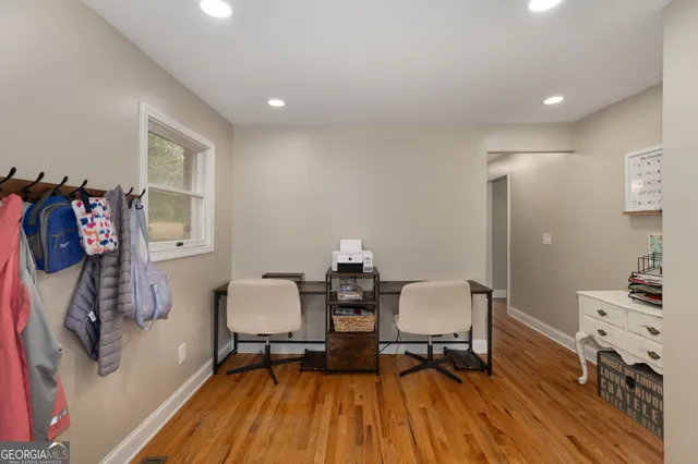 a dining room with furniture and wooden floor