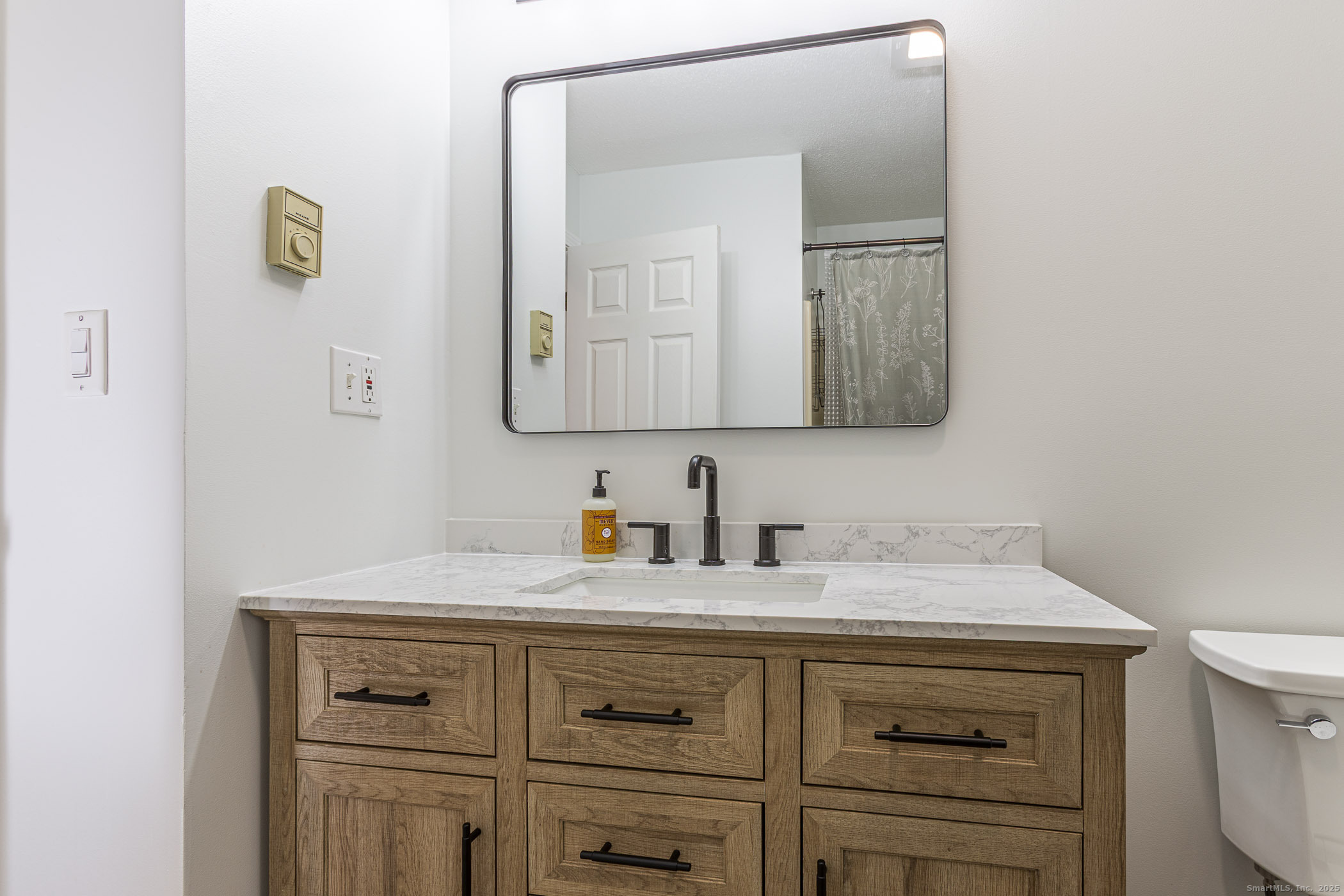 187 Lovers Lane, Unit 61 Torrington, CT 06790 - Photo 12 of 29 a bathroom with a sink a vanity and a mirror
