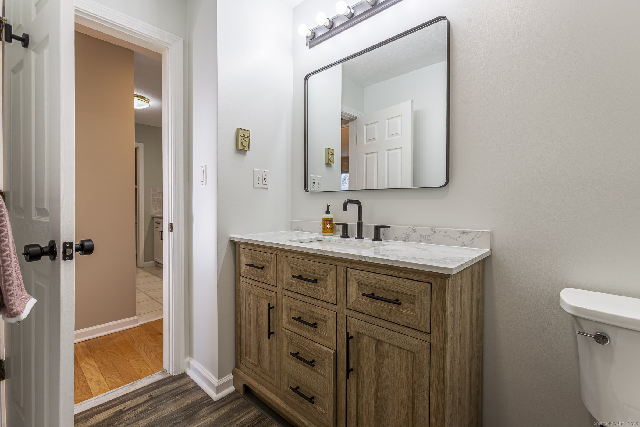 187 Lovers Lane, Unit 61 Torrington, CT 06790 - Photo 14 of 29 a bathroom with a sink vanity and a mirror