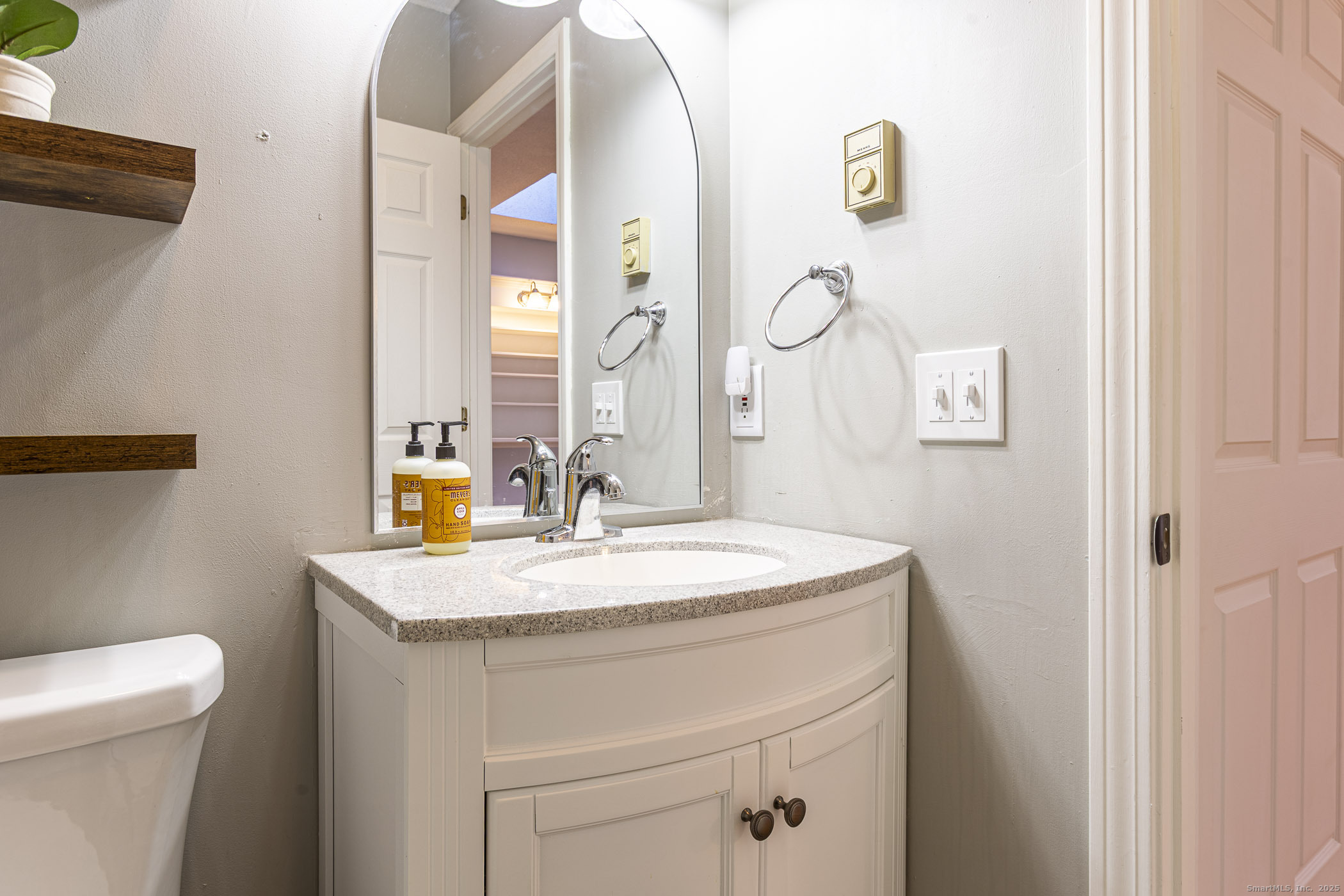 187 Lovers Lane, Unit 61 Torrington, CT 06790 - Photo 20 of 29 a bathroom with a sink a toilet and a mirror