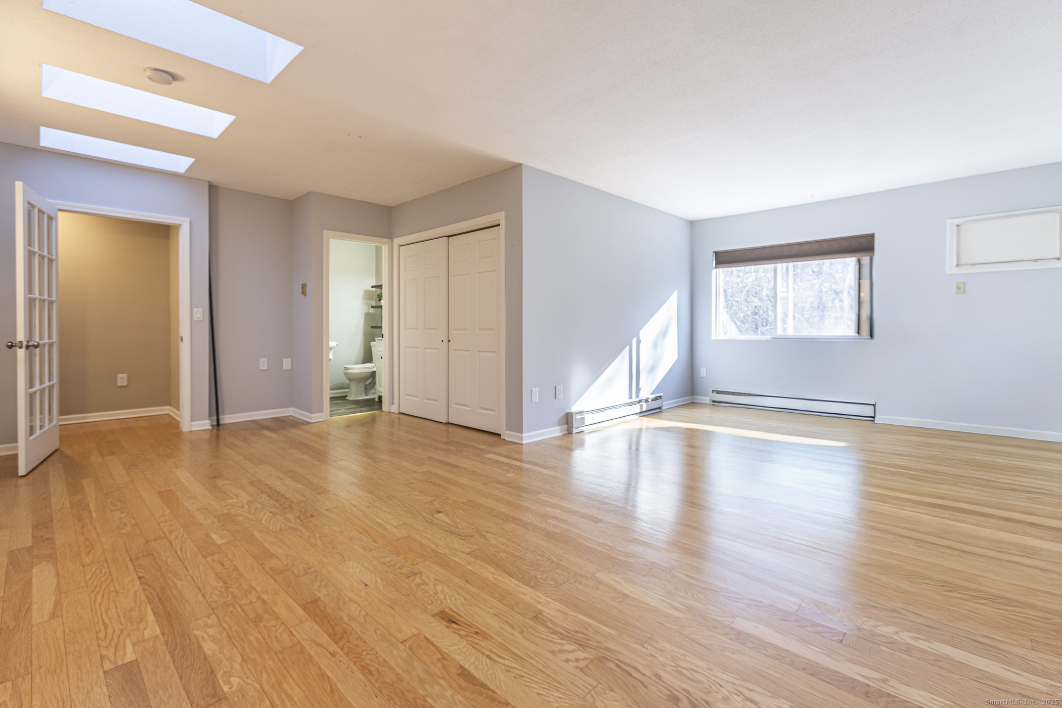 187 Lovers Lane, Unit 61 Torrington, CT 06790 - Photo 25 of 29 a view of empty room with wooden floor and fan