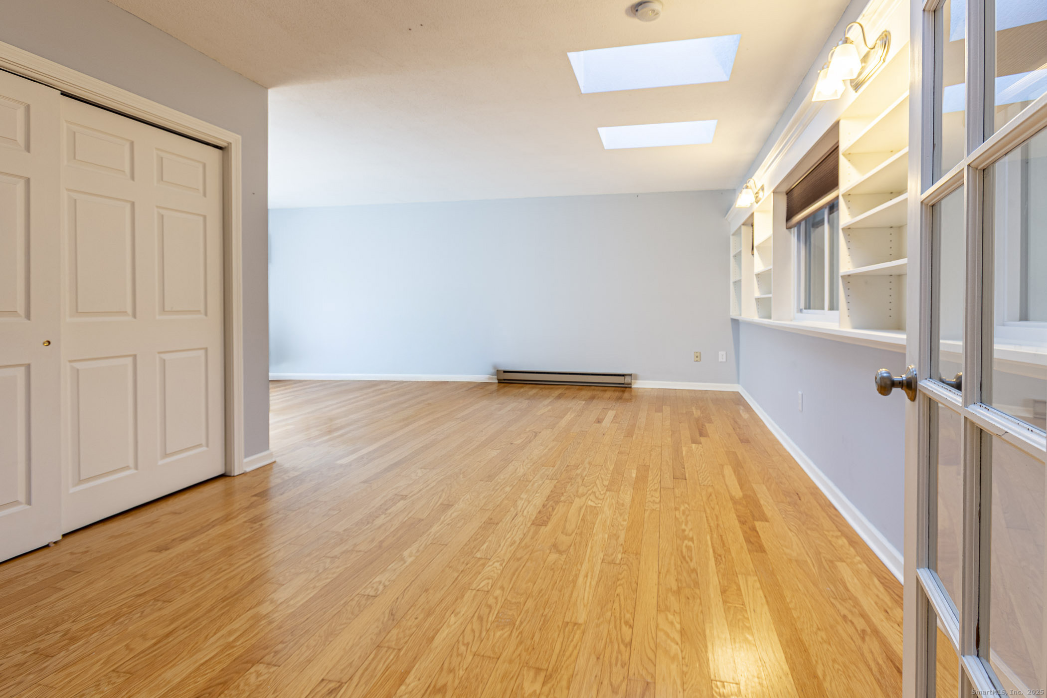 187 Lovers Lane, Unit 61 Torrington, CT 06790 - Photo 26 of 29 a view of a big room with wooden floor and staircase
