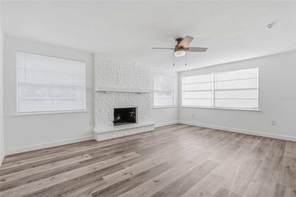 7840 Gulf Way Hudson, FL 34667 - Photo 15 of 37 an empty room with windows and fireplace