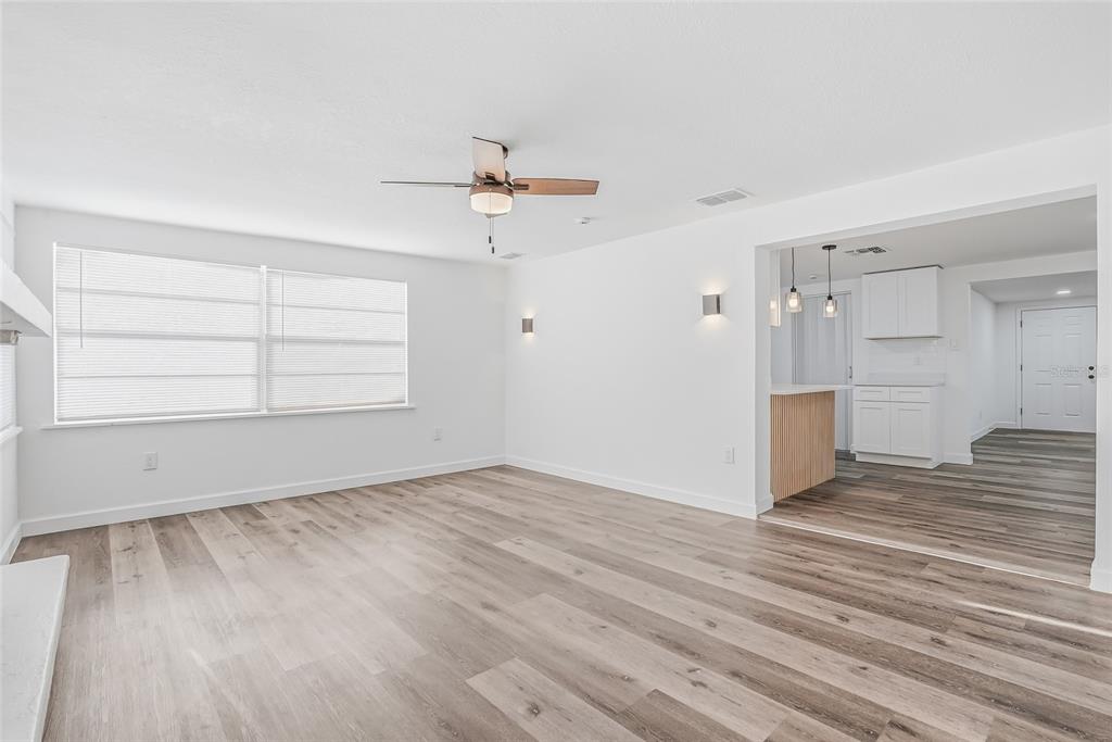 7840 Gulf Way Hudson, FL 34667 - Photo 18 of 37 wooden floor in an empty room with a window