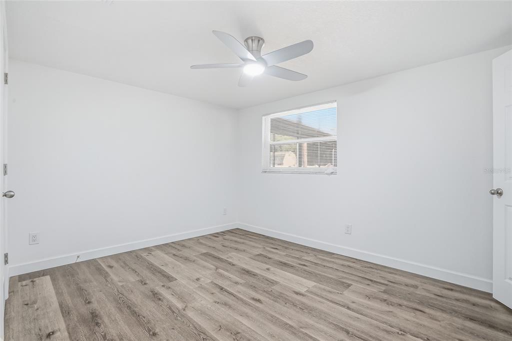 7840 Gulf Way Hudson, FL 34667 - Photo 19 of 37 an empty room with a window and ceiling fan