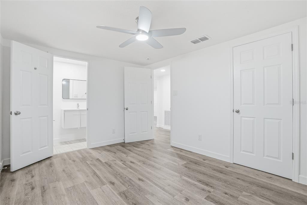 7840 Gulf Way Hudson, FL 34667 - Photo 20 of 37 an empty room with wooden floor and windows