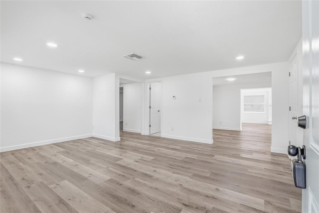 7840 Gulf Way Hudson, FL 34667 - Photo 2 of 37 a view of an empty room with wooden floor