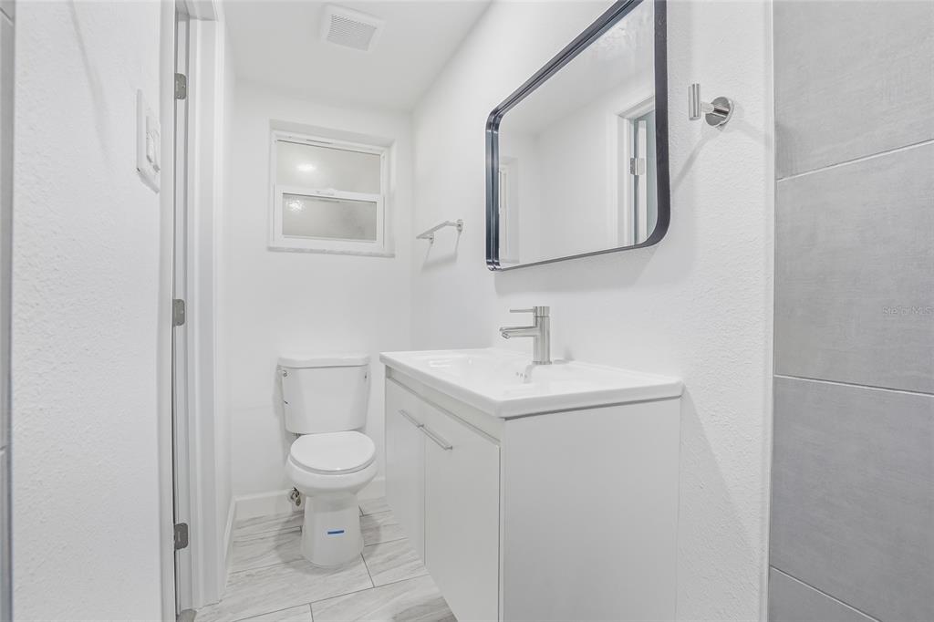 7840 Gulf Way Hudson, FL 34667 - Photo 23 of 37 a bathroom with a toilet sink and mirror