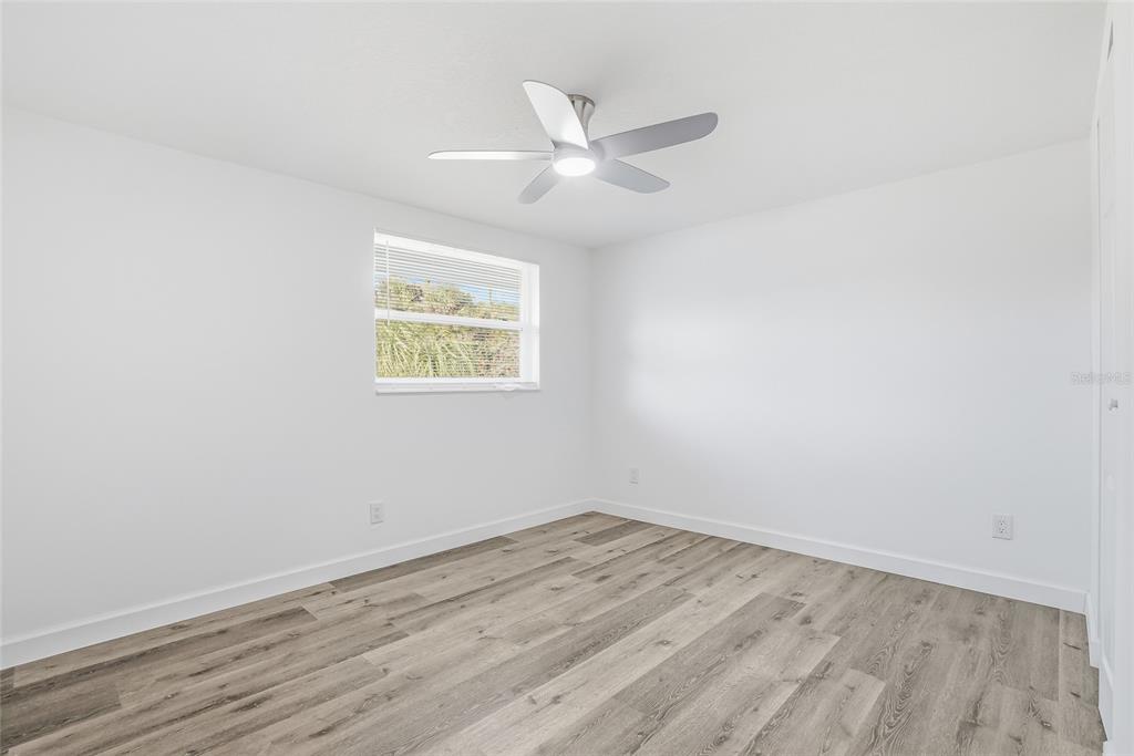 7840 Gulf Way Hudson, FL 34667 - Photo 24 of 37 an empty room with wooden floor and windows