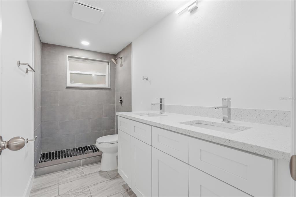 7840 Gulf Way Hudson, FL 34667 - Photo 26 of 37 a bathroom with a sink and mirror with toilet