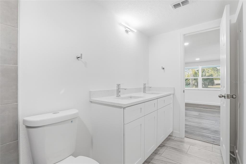 7840 Gulf Way Hudson, FL 34667 - Photo 27 of 37 a bathroom with a sink toilet and vanity