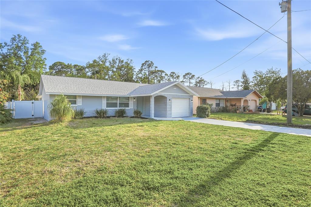 7840 Gulf Way Hudson, FL 34667 - Photo 34 of 37 a front view of a house with a yard