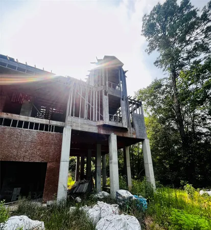 a front view of a house with lake view and a garden