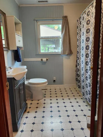 a view of a kitchen with wooden cabinet and a window