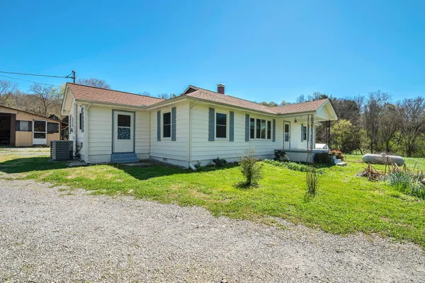 a view of an empty room with closet and a chandelier fan