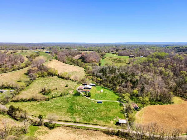 a view of a back yard of the house and a yard