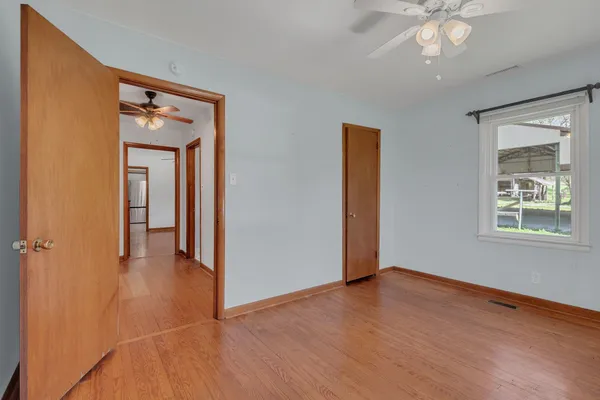 a view of a livingroom with a hardwood floor and a ceiling fan