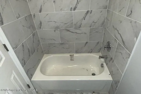 a white bath tub sitting in a bathroom