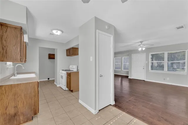 a view of a kitchen with a sink and a window