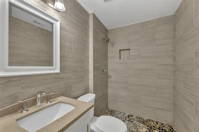 a bathroom with a sink toilet and shower