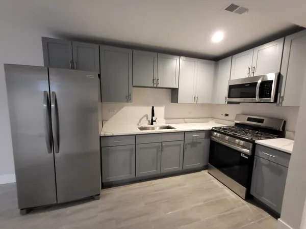 a kitchen with stainless steel appliances cabinets a sink and a stove