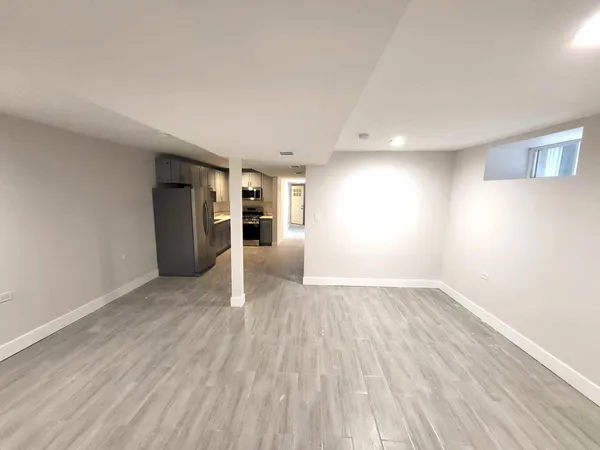 a view of empty room with wooden floor