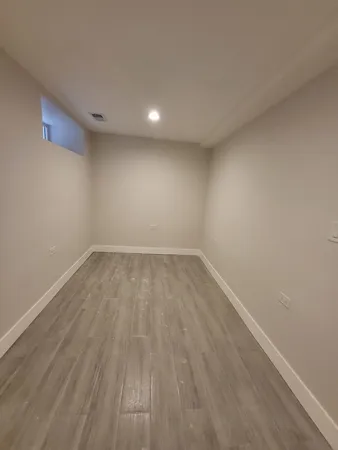 a view of room with wooden floor and natural light