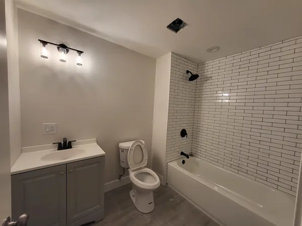 a bathroom with a toilet sink shower and bathtub