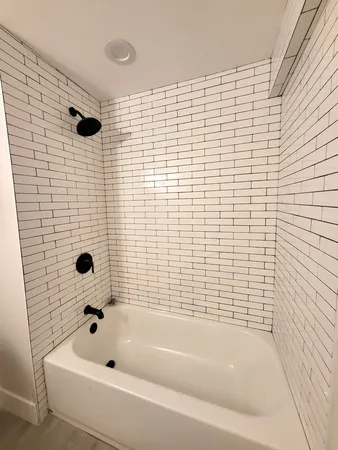 a bathroom with a bathtub and shower