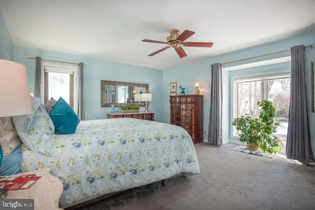 a bathroom with a granite countertop sink mirror vanity and toilet
